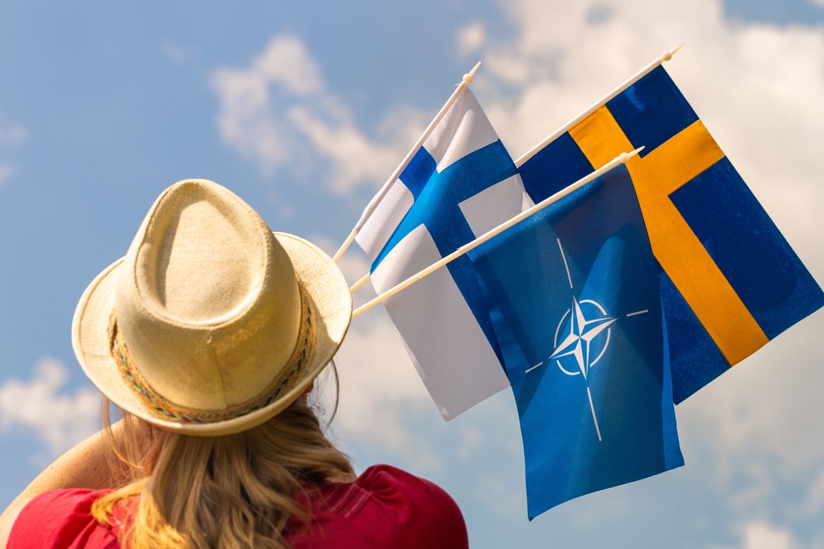 June,6,,2022,,Helsinki,,A,Woman,Holds,The,Flags,Of