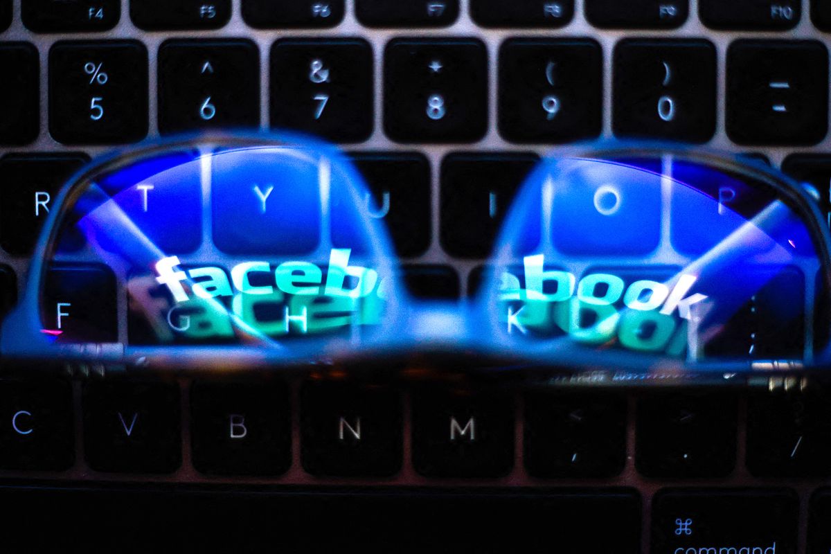 Facebook To Remove Misinformation On Vaccines, The Facebook logo is seen reflected in a pair of glasses on a computer keyboard in this photo illustration in Warsaw, Poland on March 4, 2021. As part of its policy on COVID-19-related misinformation, Facebook will start removing posts with false claims about vaccines. (Photo by Jaap Arriens/NurPhoto) (Photo by Jaap Arriens / NurPhoto / NurPhoto via AFP) Facebook To Remove Misinformation On Vaccines