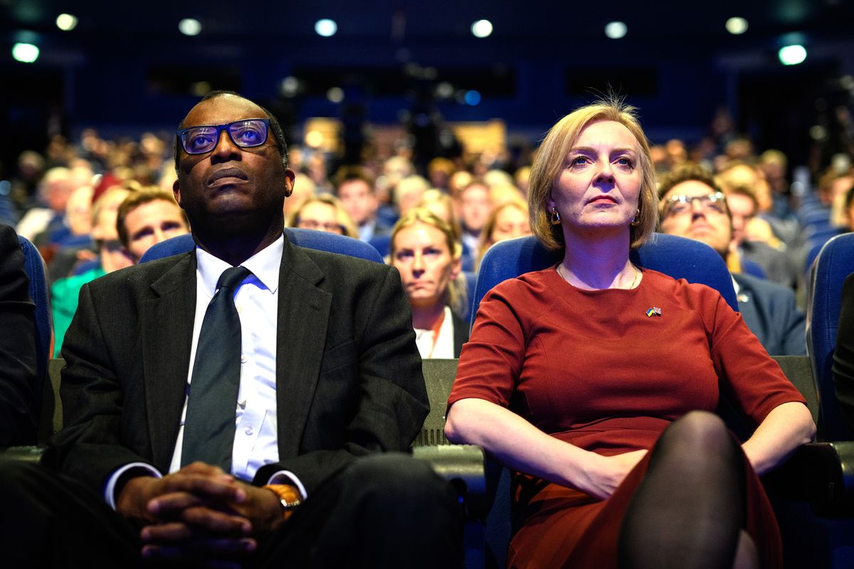 Conservative Party Conference - Day One, BIRMINGHAM, ENGLAND - OCTOBER 02: Chancellor of the Exchequer Kwasi Kwarteng (L) and Britain's Prime Minister Liz Truss watch a tribute to Queen Elizabeth II on the opening day of the annual Conservative Party conference on October 02, 2022 in Birmingham, England. This year the Conservative Party Conference will be looking at "Getting Britain Moving" with more jobs and higher salaries. However, delegates are arriving at the conference as the party lags 33 points behind Labour in the opinion polls. (Photo by Leon Neal/Getty Images)