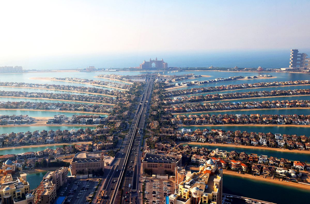 (FILES) In this file photo taken on January 10, 2022 A picture shows the Palm Jumeirah in the Gulf emirate of Dubai. - The United Arab Emirates did not qualify for the Qatar World Cup but it will be a winner anyway if an overspill of fans floods its hotels, restaurants and planes. Dubai is gearing up with fan zones announced at parks, beaches and in the financial centre, and hotels offering special packages. (Photo by Giuseppe CACACE / AFP) FILES-FBL-QAT-WC-2022-UAE-ECONOMY