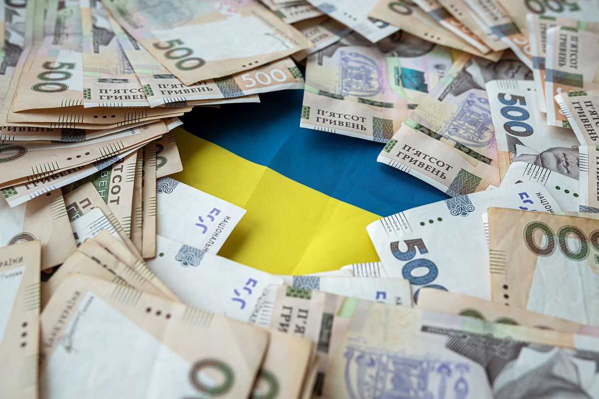 Ukrainian,Hryvnia,Lying,On,National,Blue,Yellow,Flag,Of,Ukraine.