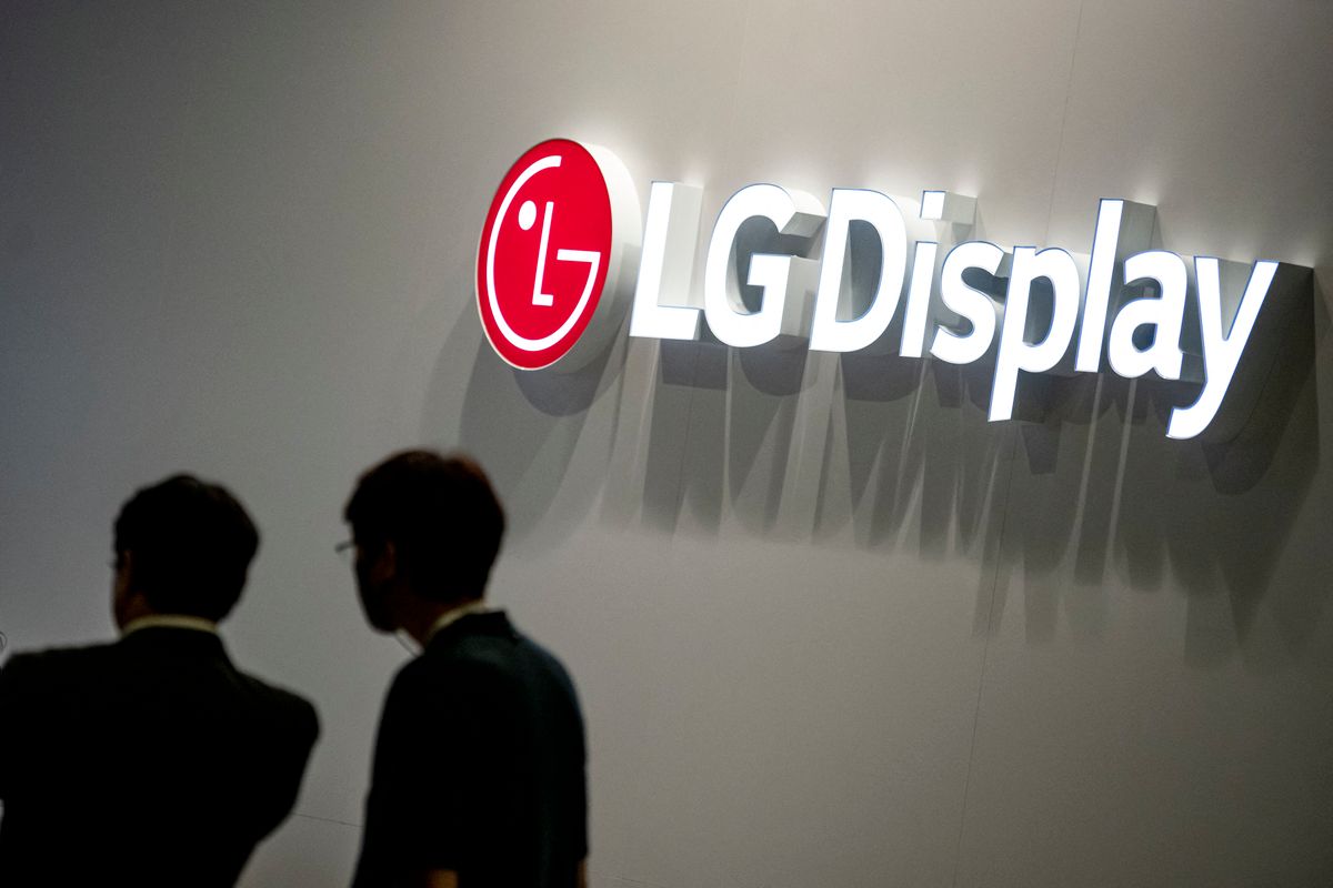 04 September 2022, Berlin: Two visitors at the electronics fair IFA stand in front of the logo of LG Display. More than 1100 exhibitors show the novelties of consumer electronics and home appliances at IFA.