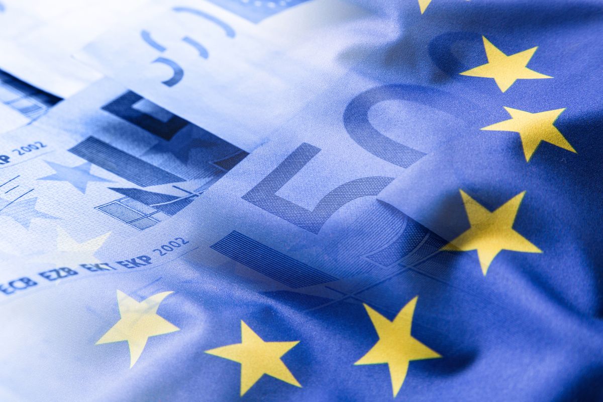 Colorful,Waving,European,Union,Flag,On,A,Euro,Money,Background.