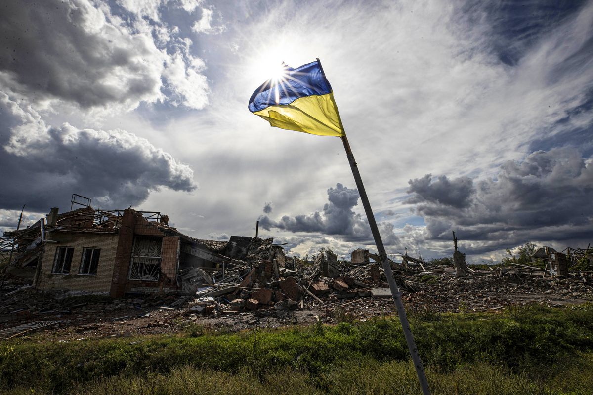 Russia - Ukraine war continues, DOLINA, DONETSK, UKRAINE - SEPTEMBER 24: Ukrainian flag waves in a residential area heavily damaged in the village of Dolyna in Donetsk Oblast, Ukraine after the withdrawal of Russian troops on September 24, 2022. Many houses and St. George's Monastery were destroyed in the Russian attacks. Ukraine said on Saturday that its soldiers were entering the city of Lyman in the eastern region of Donetsk, which Russia had annexed a day earlier. (Photo by Metin Aktas/Anadolu Agency via Getty Images)