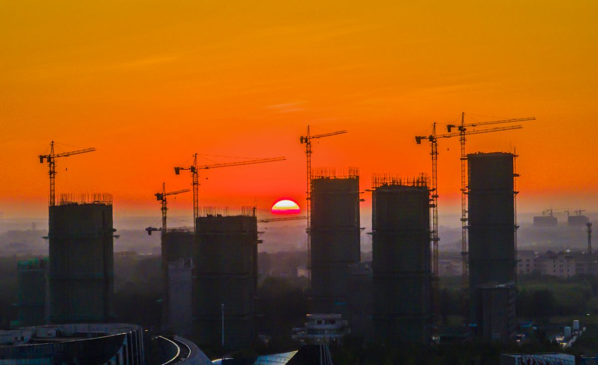 Infrastructure Construction in China, SUQIAN, CHINA - AUGUST 24, 2022 - Cranes stand in the morning at a key construction site in Suqian, Jiangsu Province, China, Aug 24, 2022. (Photo credit should read CFOTO/Future Publishing via Getty Images)