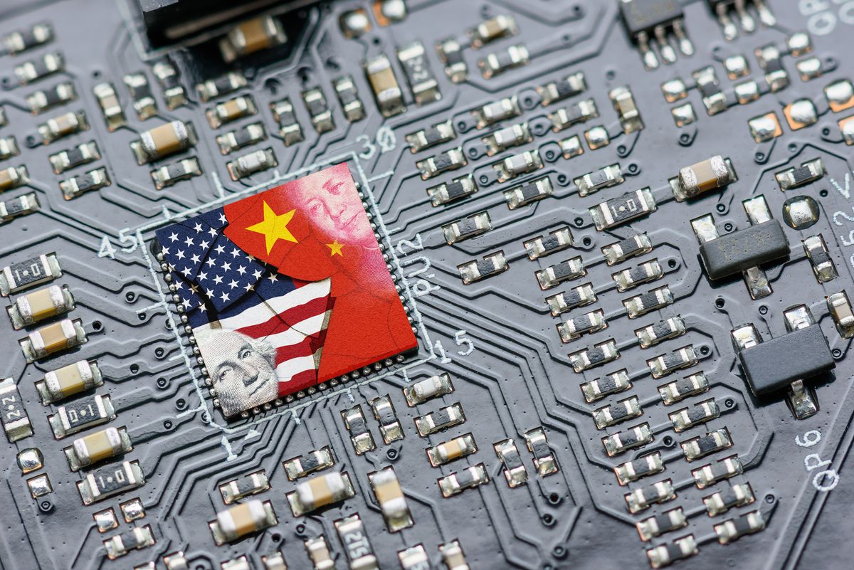 Flag of USA and China on a processor, CPU or GPU microchip on a motherboard. US companies have become the latest collateral damage in US - China tech war. US limits, restricts AI chips sales to China. Flag of USA and China on a processor, CPU or GPU microchip on a motherboard. US companies have become the latest collateral damage in US - China tech war. US limits, restricts AI chips sales to China.
