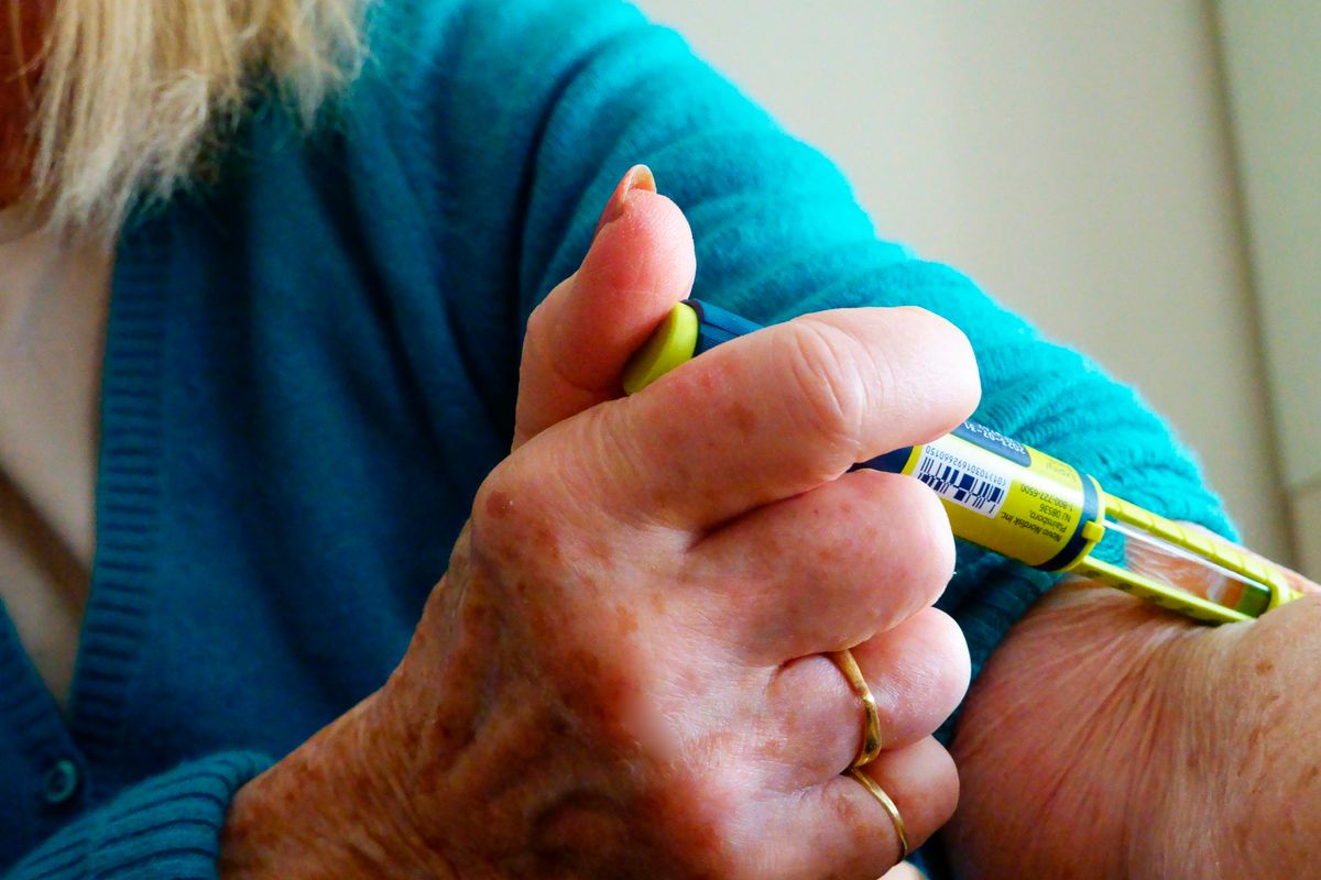 Mature woman injecting insulin with Trebisa pen