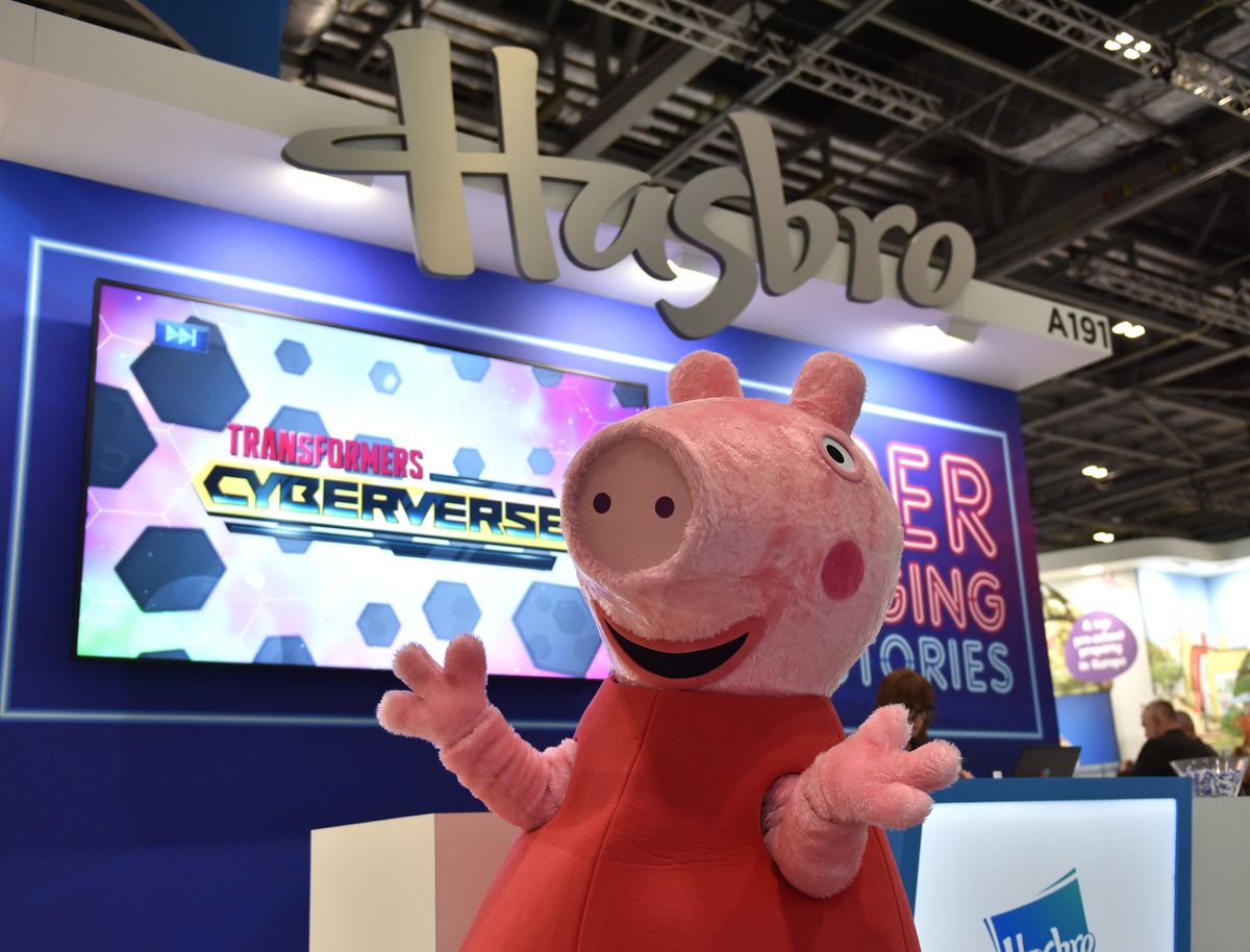 LONDON, ENGLAND - NOVEMBER 18: A Peppa Pig character poses  under the Hasbro logo during Brand Licensing Europe at ExCel on November 18, 2021 in London, England. Brand Licensing Europe (BLE) is dedicated to licensing and brand extension, bringing together retailers, licensees and manufacturers businesses looking to discover and secure deals with the most sought-after brands, characters and images available for licensing.  