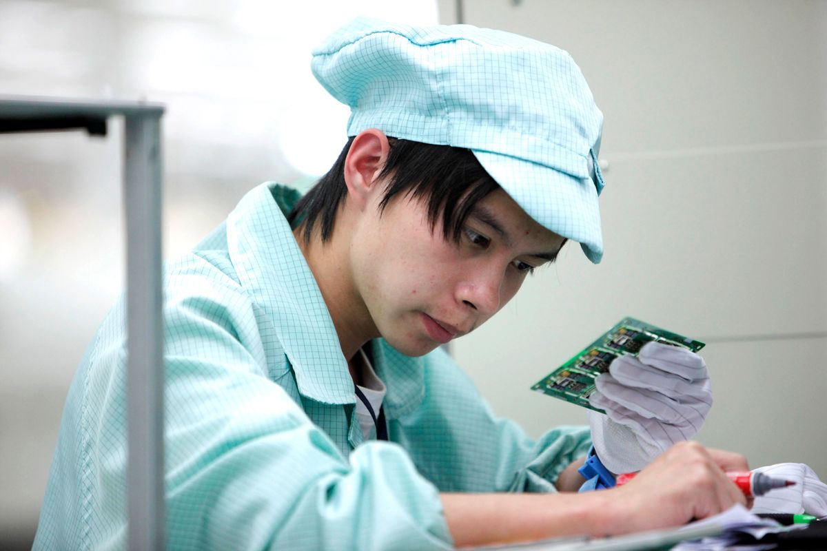 Networking Products Are Produced At ZTE Corp. Factory An employee works on a communications equipment assembly line at a  ZTE Corp. factory in Shenzhen, Guangdong province, China, on Tuesday, Nov. 17, 2009. ZTE Corp. manufactures and markets networking and telecommunications equipment. Photographer: Qilai Shen/Bloomberg via Getty Images