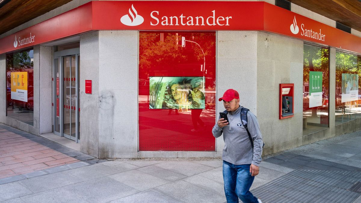 MADRID, SPAIN - 2022/07/22: A pedestrian walks past the Spanish multinational commercial bank and financial services of Santander branch seen in Spain.
