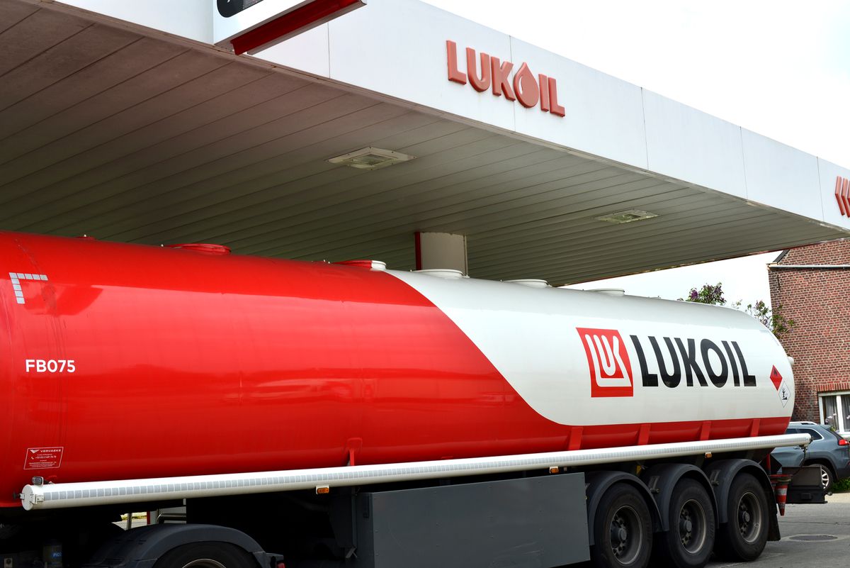 Wilsele,,Vlaams-brabant,,Belgium,-,May,05,,2022:,Stationary,Supply,Truck, Wilsele, Vlaams-Brabant, Belgium - May 05, 2022: stationary supply truck LUKOIL delivering, filling the petrol tanks in petrol station LUKOIL Aarschotsesteenweg. Side view with logo red and white, Wilsele, Vlaams-Brabant, Belgium - May 05, 2022: stationary supply truck LUKOIL delivering, filling the petrol tanks in petrol station LUKOIL Aarschotsesteenweg. Side view with logo red and white