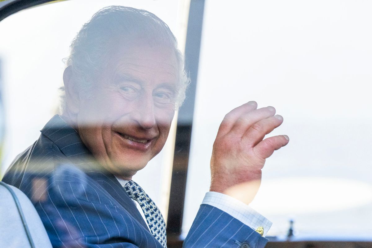 Britain's King Charles III waves from the car as he leaves after meeting with members and staff of the association "Project Zero", an organisation dedicated to engaging young people in positive activities, promoting social inclusion and strengthening community cohesion, during a visit of the center in Walthamstow, in east London, on October 18, 2022. 
