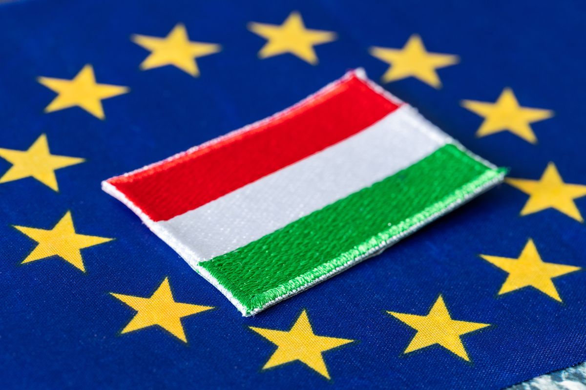 flag of Hungary in the center of the European Union flag, Concept, Difficult cooperation between Budapest and Brussels flag of Hungary in the center of the European Union flag, Concept, Difficult cooperation between Budapest and Brussels, 
