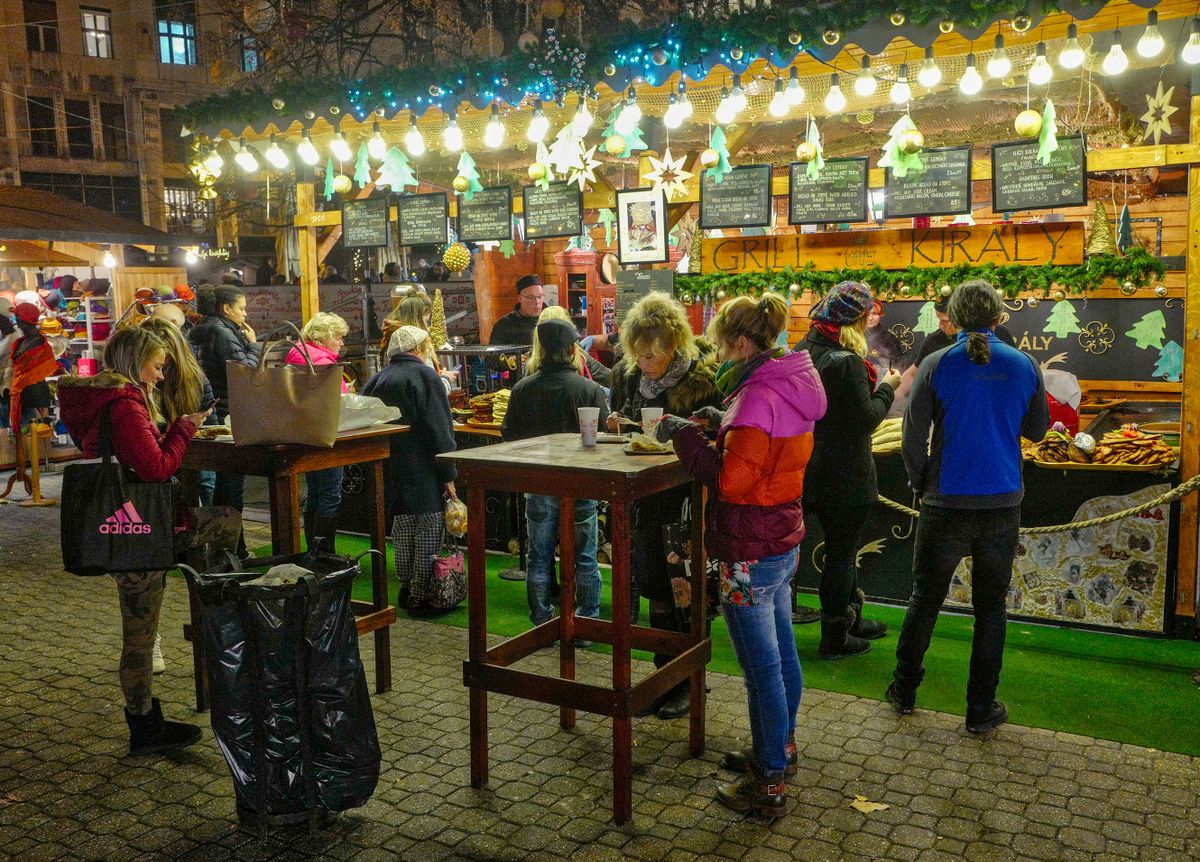 BUDAPEST, HUNGARY - DECEMBER 02:  Tourists and locals stand at one of the food stalls at the Christmas Market on December 2, 2016 in Budapest, Hungary. The traditional Christmas market and lights will stay until 1st January 2017. 
