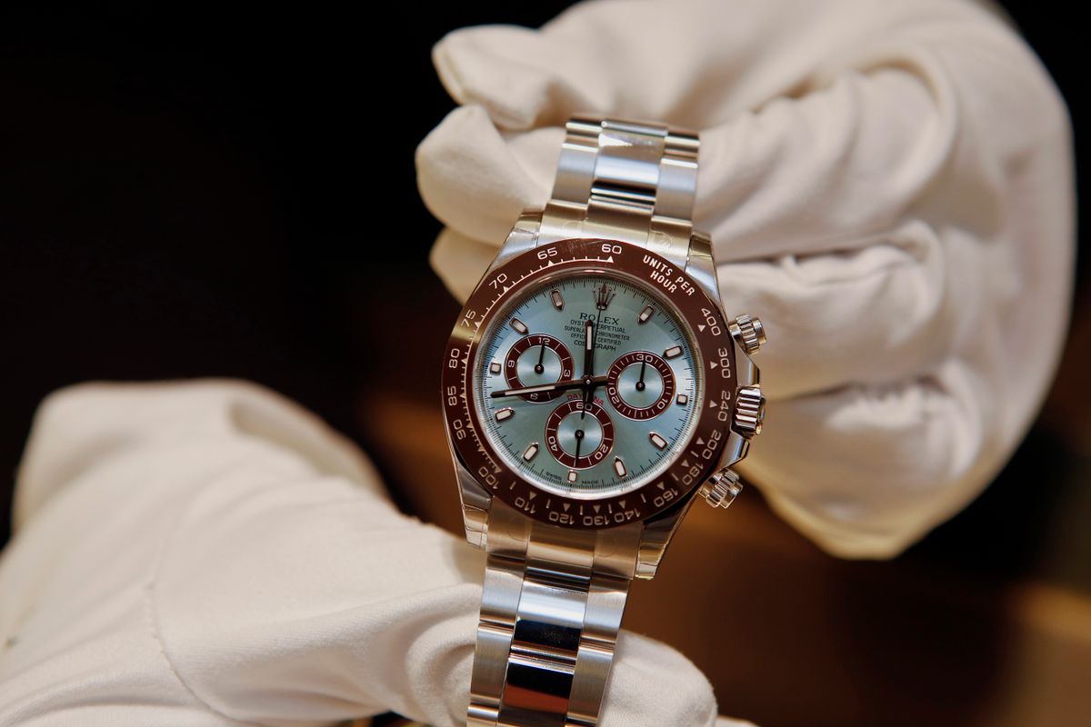 A salesperson displays the Rolex Group Daytona 50th anniversary watch for a photograph at the GEARYS Rodeo Drive Rolex store in Beverly Hills, California, U.S., on Monday, Dec. 9, 2013. Consensus calls for global luxury goods sales to grow 10% and EPS to expand 14.3% in 2014. Photographer: Patrick T. Fallon/Bloomberg via 