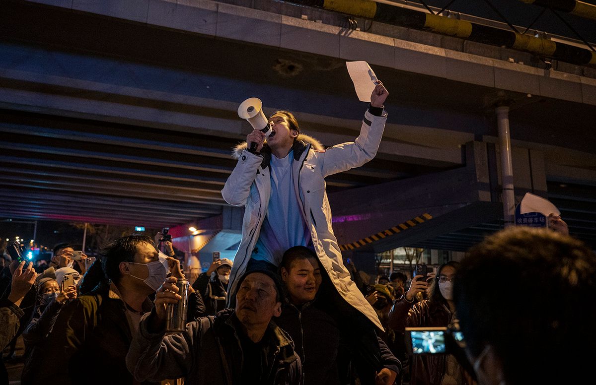 Protest in Beijing Against China Covid Measures
BEIJING, CHINA -NOVEMBER 28: Protesters shout slogans during a protest against Chinas strict zero COVID measures on November 28, 2022 in Beijing, China. Protesters took to the streets in multiple Chinese cities after a deadly apartment fire in Xinjiang province sparked a national outcry as many blamed COVID restrictions for the deaths. (Photo by Kevin Frayer/Getty Images)