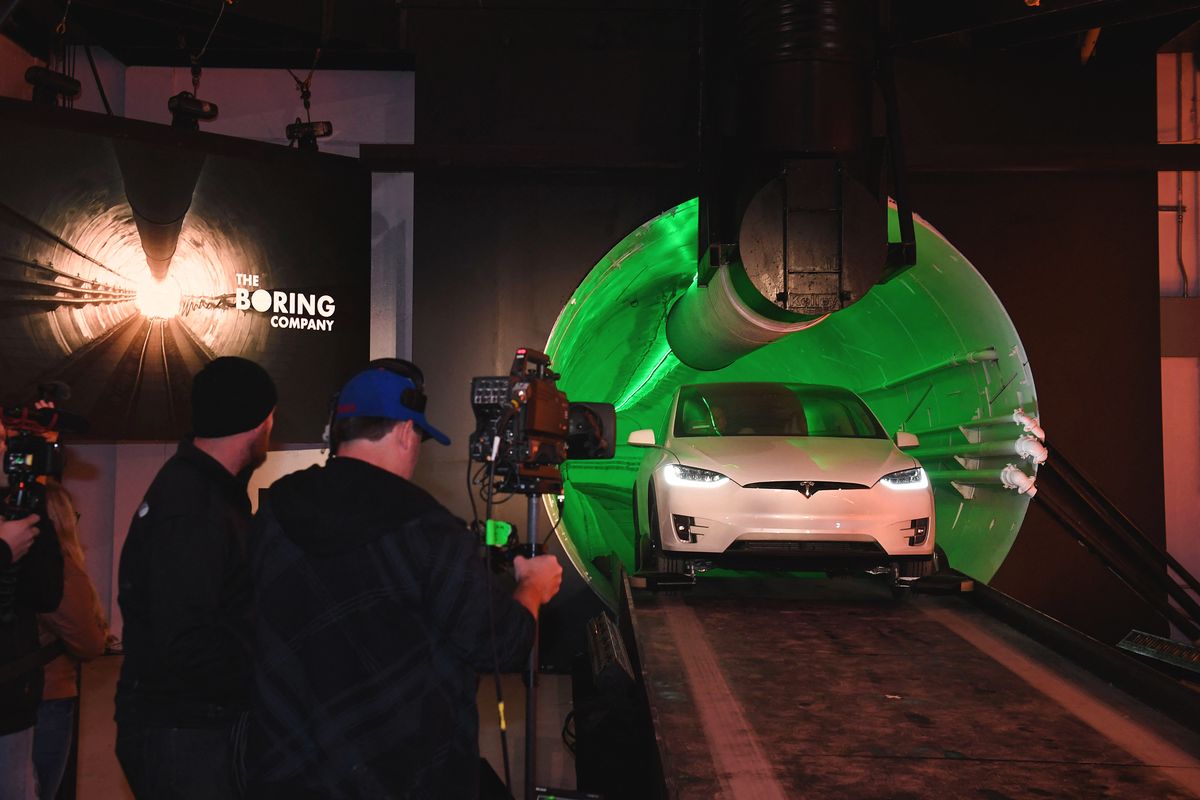 Boring Company Tunnel, Elon Musk, co-founder and chief executive officer of Tesla Inc., arrives in a modified Tesla Model X electric vehicle during an unveiling event for the Boring Co. Hawthorne test tunnel in Hawthorne, south of Los Angeles on December 18, 2018. - On Tuesday night December 18, 2018, Boring Co. will officially open the Hawthorne tunnel, a preview of Elon Musk's larger vision to ease L.A. traffic. (Photo by Robyn Beck / POOL / AFP)