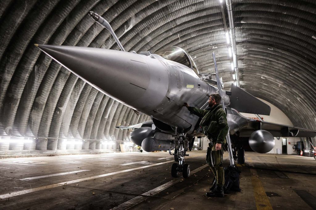 A Rafale jet fighter pilot checks and prepares his aircraft before leaving for a four-month mission to protect the airspace of the Baltic States, as France is deploying four Rafale fighters to Lithuania under NATO mandate, from BA 118 in Mont-de-Marsan, southwestern France, on November 25, 2022. (Photo by Thibaud MORITZ / AFP)