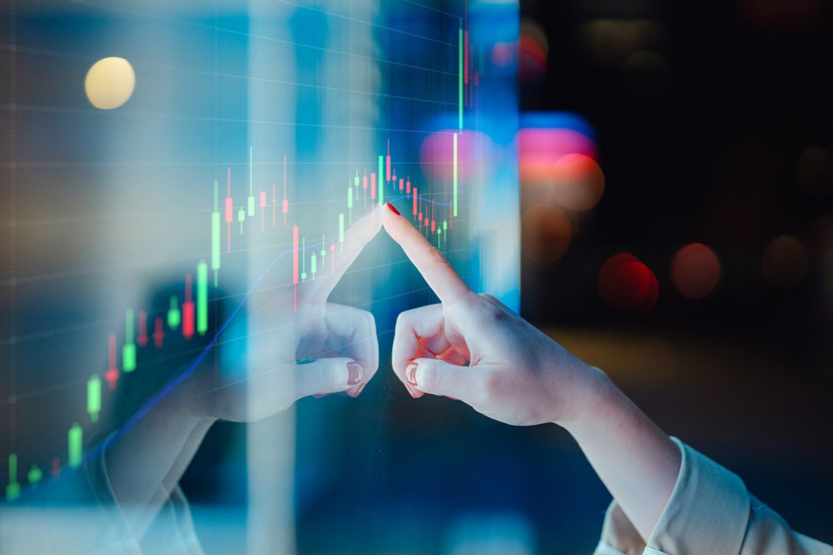 Businesswomen touching stock market graph on a virtual screen display, Close-up of female hand touching illuminated display screen, managing investment with financial date. Crypto-asset management.