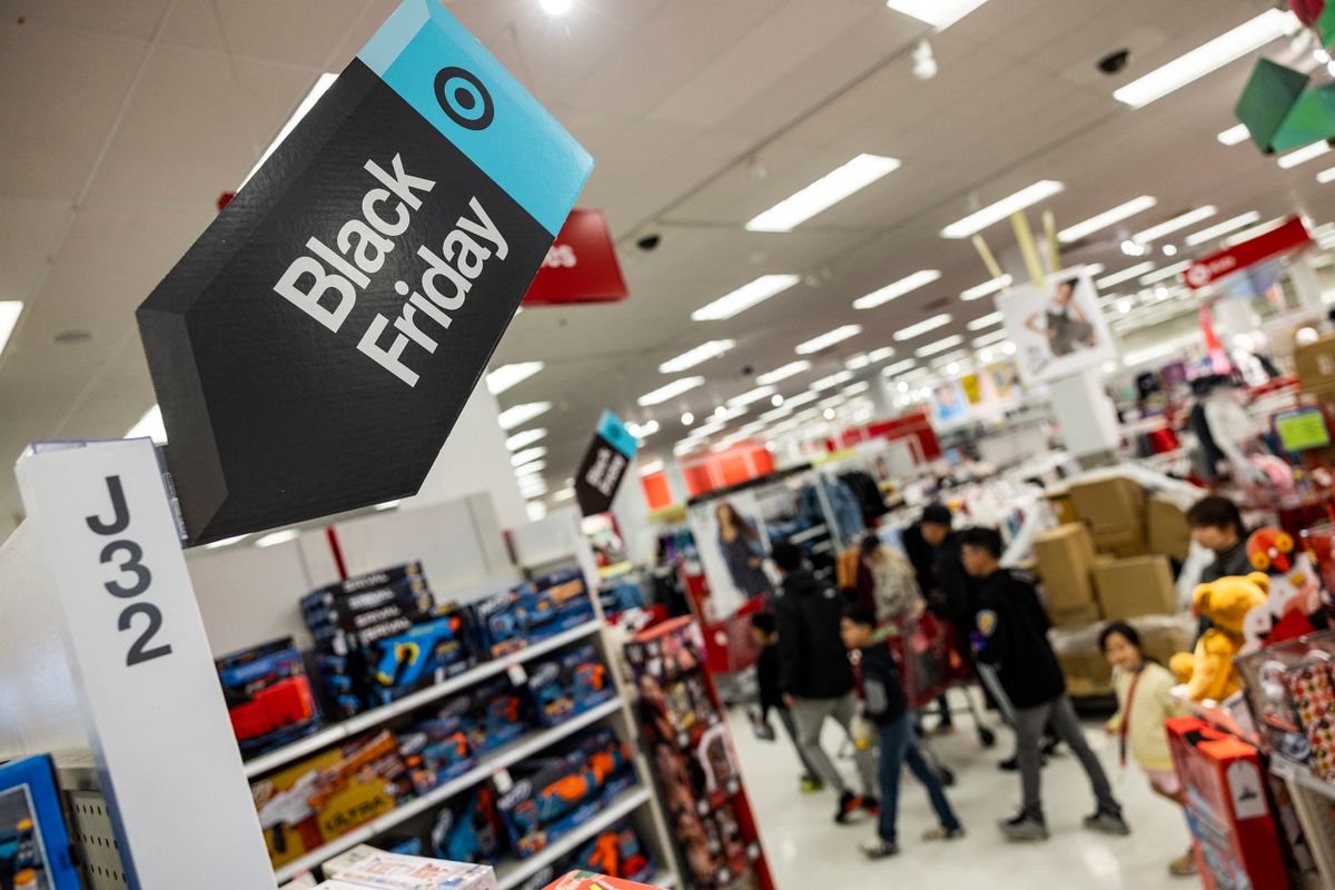 Black Friday sales signs are posted at a Target store in Rockville, Maryland, on November 25, 2022 . - With inflation on the rise, retailers are expecting that many shoppers will be looking for especially good deals as discretionary spending falls.