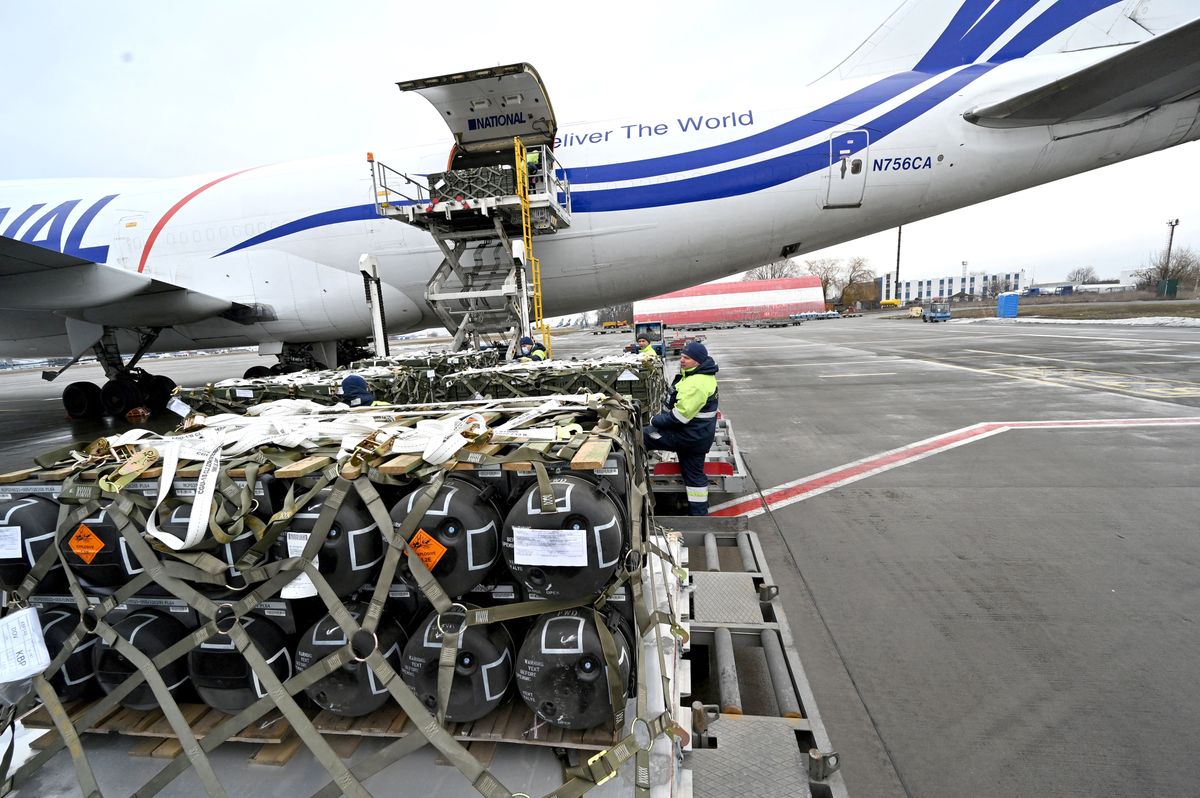 Employees unload a Boeing 747-412 plane with the FGM-148 Javelin, American man-portable anti-tank missile provided by US to Ukraine as part of US military support to Ukraine, at Kyiv's airport Boryspil on February 11,2022, amid the crisis linked with the threat of Russia's invasion. (Photo by Sergei SUPINSKY / AFP)