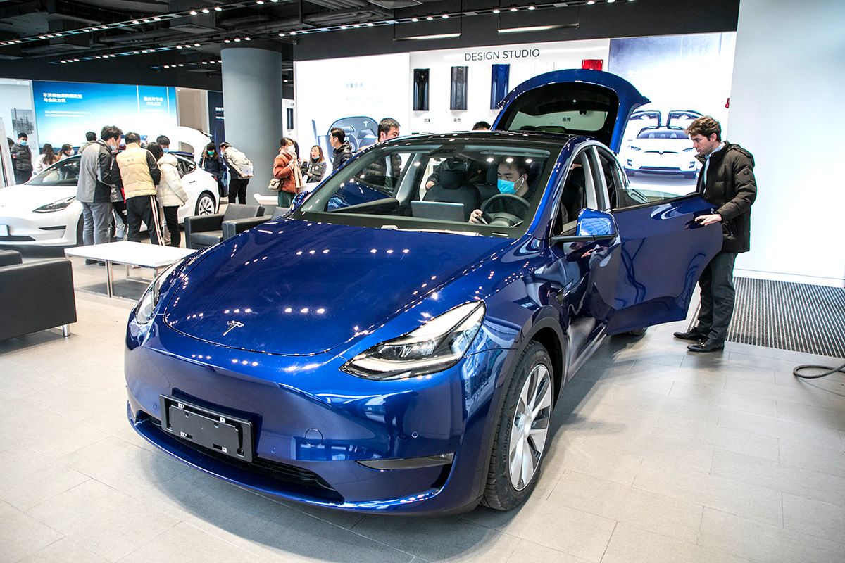 Tesla's Shanghai-made Model Y goes on sale in Shanghai Tesla's Shanghai-made Model Y with the lower price points attracts buyers to take a test drive in one of its speciality stores in Shanghai, China, 6 January 2021. (Photo by Stringer / Imaginechina via AFP)