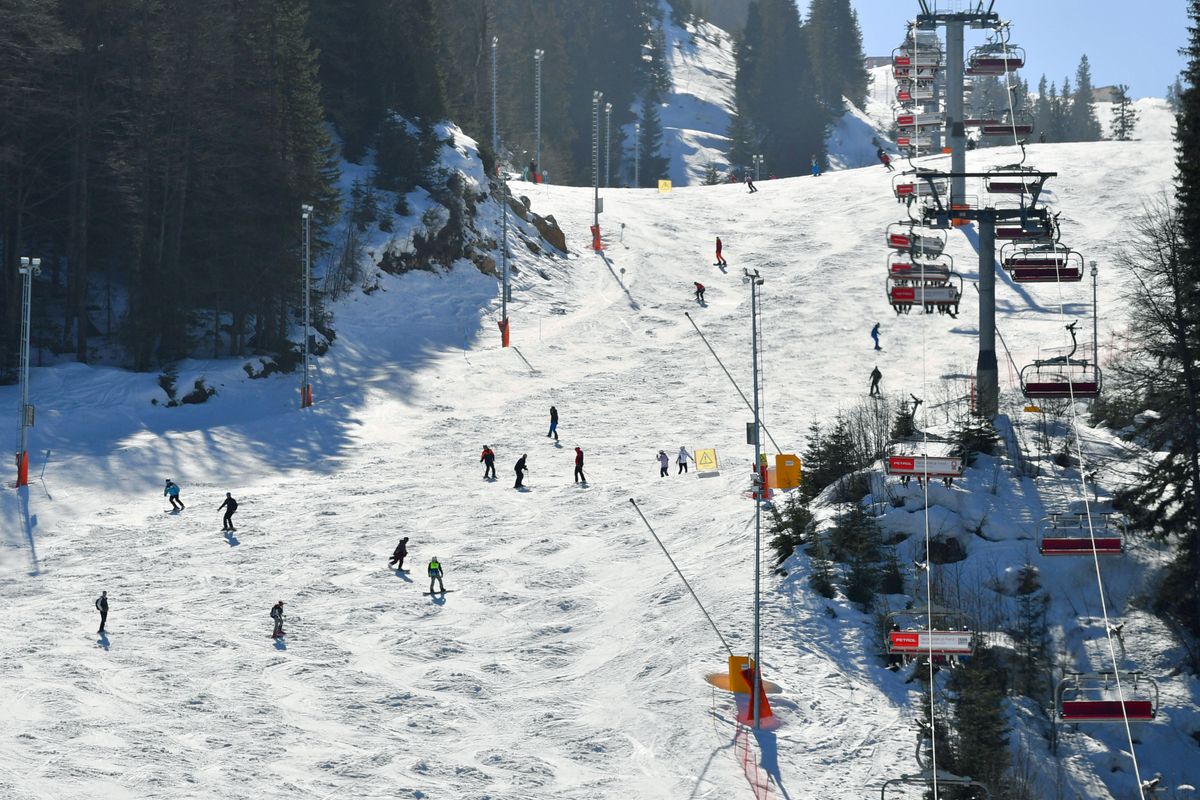 BOSZNIA
Snowboarders glide down the slopes of Mount Jahorina near the Bosnian capital of Sarajevo, on February 26, 2021. - Although some disease prevention measures have implemented, most transport systems are functional and many accommodation option are available. Jahorina Olympic centre is recording a high numbers of visitors in the winter 2020/21 season. Domestic visitors as well as from neighbouring countries, where ski centres have been closed for most of the season in order to prevent spread of the new coronavirus(Covid-19). (Photo by ELVIS BARUKCIC / AFP)