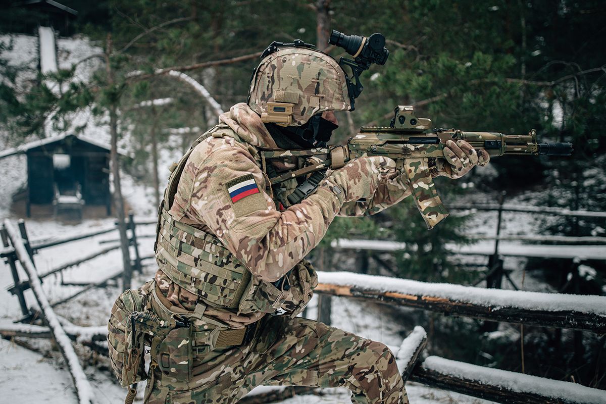 Russian,Spetsnaz,Soldier,With,Kalashnikov,Tactical,Assault,Rifle,In,Camouflage Russian spetsnaz soldier with Kalashnikov tactical assault rifle in camouflage uniform in Dagestan winter mountains. Text translation: Russia.
