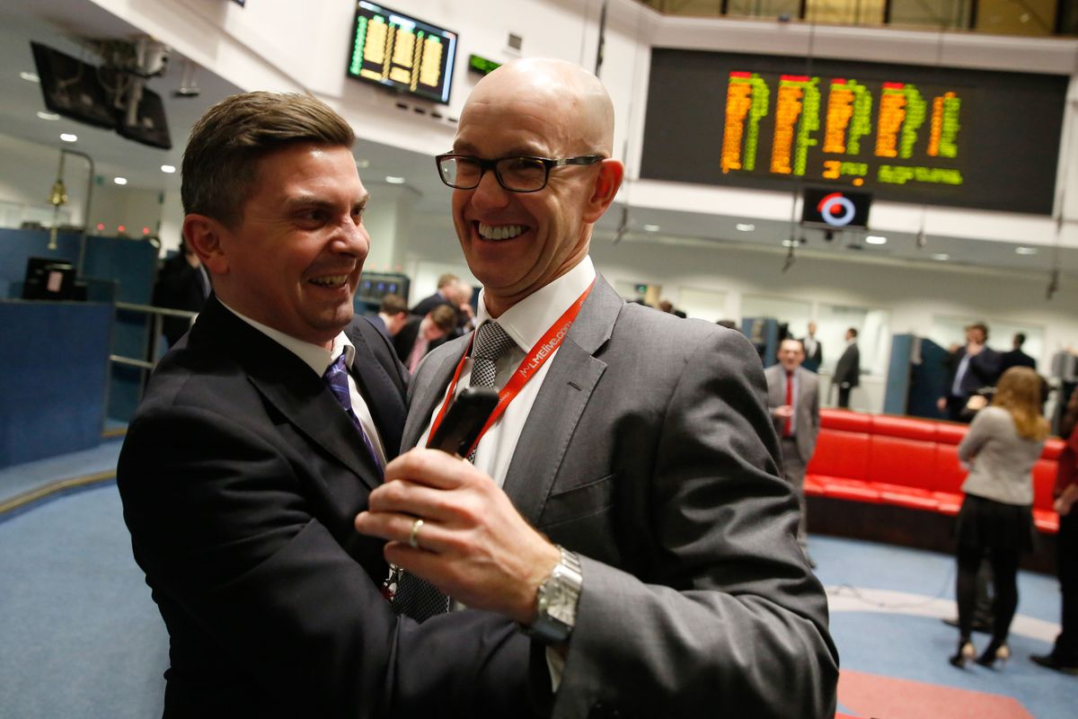 Traders embrace at the end of the day's trading on the trading floor of the open outcry pit at the London Metal Exchange (LME), on the last day of trading at their Leadenhall Street premises, in London, U.K., on Wednesday, Jan. 27, 2016. The London Metal Exchange will move to a new building at 10 Finsbury Square. 