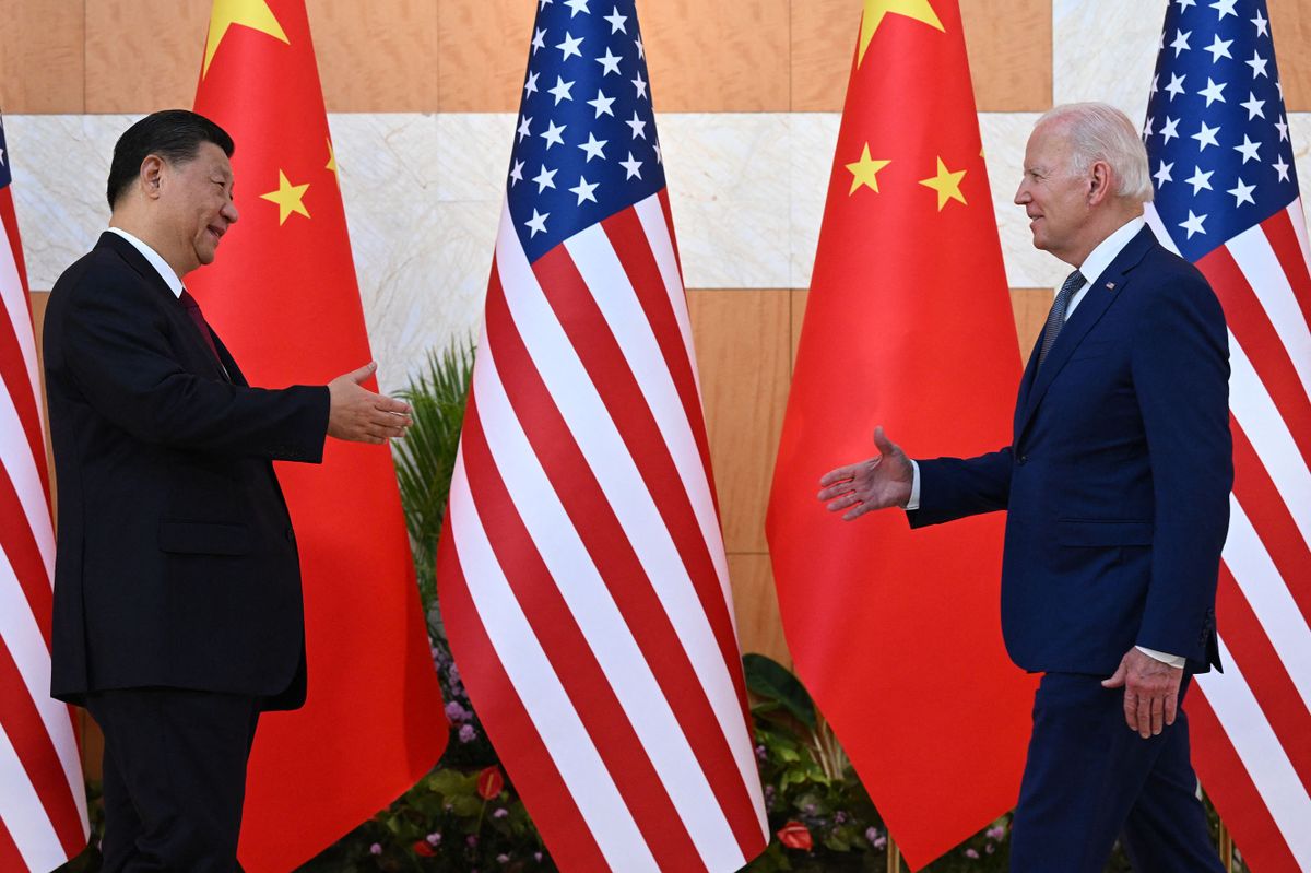 US President Joe Biden (R) and China's President Xi Jinping (L) shake hands as they meet on the sidelines of the G20 Summit in Nusa Dua on the Indonesian resort island of Bali on November 14, 2022. 