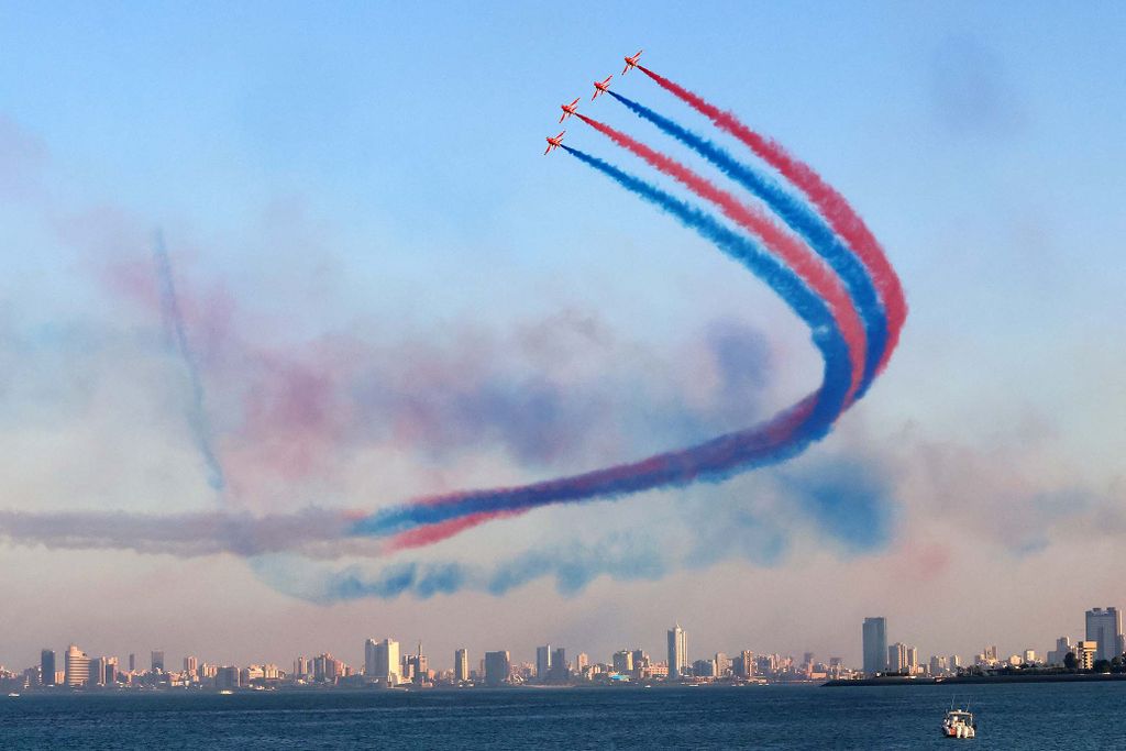 The British Royal Air Force's (RAF) aerobatic team, the "Red Arrows", performs aerial manoeuvres during an airshow in Kuwait City on November 21, 2022. (Photo by YASSER AL-ZAYYAT / AFP)