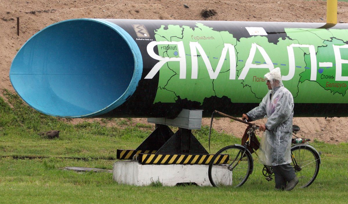 (FILES) In this file photo taken on June 21, 2010 a man rides  his bicycle near a symbolic monument, a section of a gas pipeline Yamal - Europe in Slonim, some 200 km outside Minsk. - The government in Warsaw said on November 14, 2022 Poland was seizing Gazprom's share in EuRoPol Gaz, the company that owns the Polish section of the Yamal-Europe natural gas pipeline.