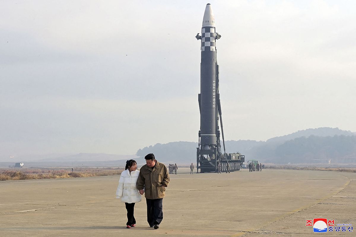 This picture taken on November 18, 2022 and released from North Korea's official Korean Central News Agency (KCNA) on November 19, 2022 shows North Korea's leader Kim Jong Un (R) walking with his daughter as he inspects a new intercontinental ballistic missile (ICBM) "Hwasong Gun 17", at Pyongyang International Airport. - North Korean leader Kim Jong Un said he would respond to US threats with nuclear weapons, state media said on November 19, after Kim personally oversaw Pyongyang's latest launch of intercontinental ballistic missile. (Photo by KCNA VIA KNS / AFP) / South Korea OUT / REPUBLIC OF KOREA OUT---EDITORS NOTE--- RESTRICTED TO EDITORIAL USE - MANDATORY CREDIT "AFP PHOTO/KCNA VIA KNS" - NO MARKETING NO ADVERTISING CAMPAIGNS - DISTRIBUTED AS A SERVICE TO CLIENTS / THIS PICTURE WAS MADE AVAILABLE BY A THIRD PARTY. AFP CAN NOT INDEPENDENTLY VERIFY THE AUTHENTICITY, LOCATION, DATE AND CONTENT OF THIS IMAGE --- /