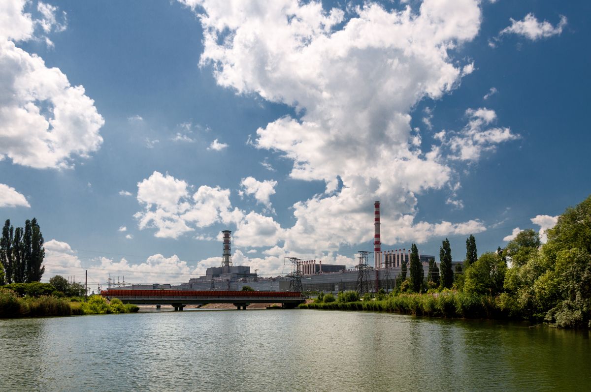 Kursk Nuclear Power Plant reflected in a calm water surface Kursk Nuclear Power Plant reflected in a calm water surface. Mist over the water. Kursk Nuclear Power Plant reflected in a calm water surface. Mist over the water.