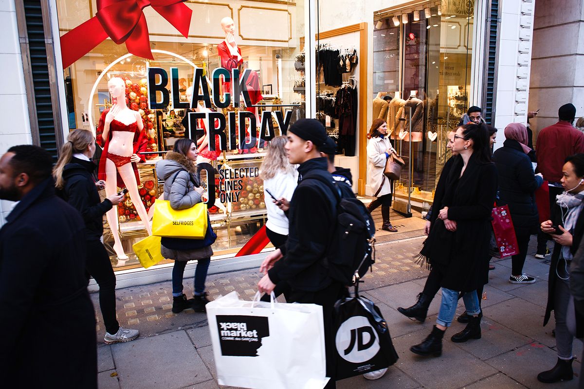 Shoppers pass a sign advertising Black Friday discounts at a lingerie store on Oxford Street in London, England, on November 29, 2019. (Photo by David Cliff/NurPhoto via Getty Images)