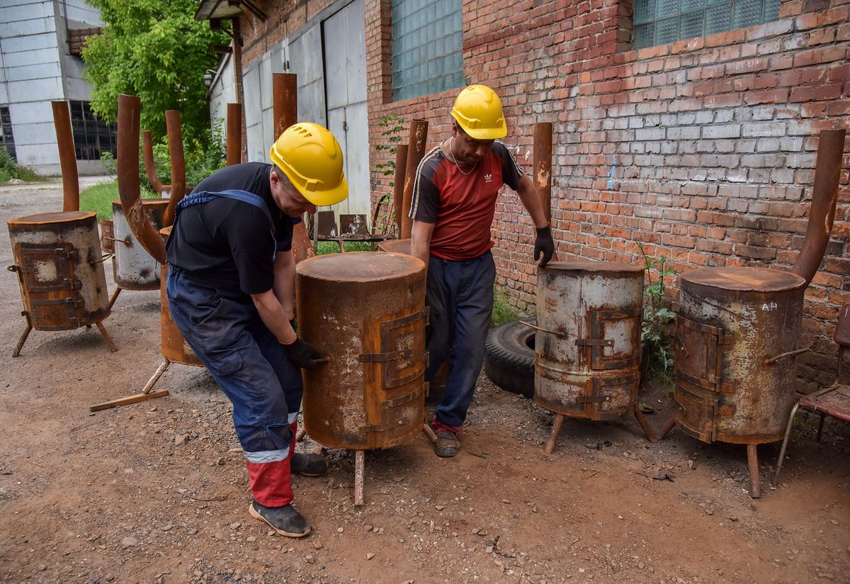 Workers of the Lviv utility company carry a ready-made