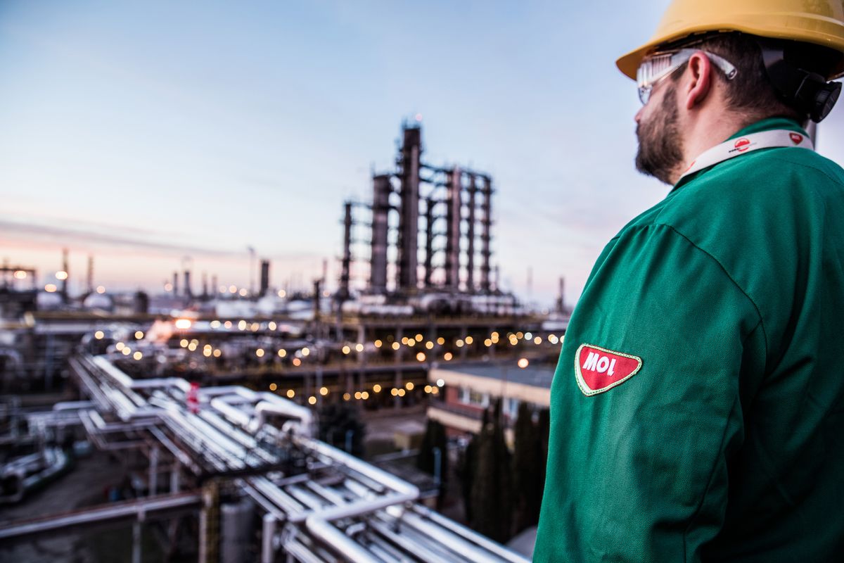 MOL Hungarian Oil & Gas Plc Refinery As Oil Trades Near Three-Month High, An employee stands on an oil storage tank against a backdrop of oil cracking towers in the Duna oil refinery, operated by MOL Hungarian Oil & Gas Plc, in Szazhalombatta, Hungary, on Monday, Feb. 13, 2019. Oil traded near a three-month high as output curbs by OPEC tightened global supply while trade talks between the U.S. and China lifted financial markets. Photographer: Akos Stiller/Bloomberg via Getty Images