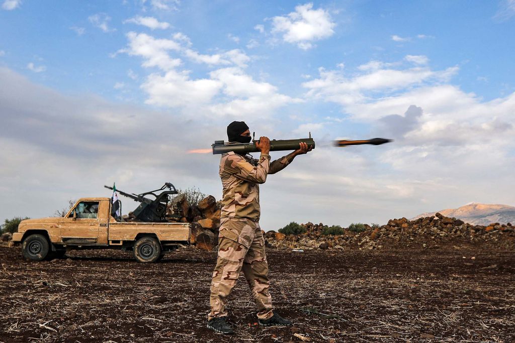 A Syrian fighter fires a rocket-propelleged grenade (RPG) during military drills by the Turkish-backed "Suleiman Shah Division" in the opposition-held Afrin region of northern Syria on November 22, 2022. (Photo by Bakr ALKASEM / AFP)