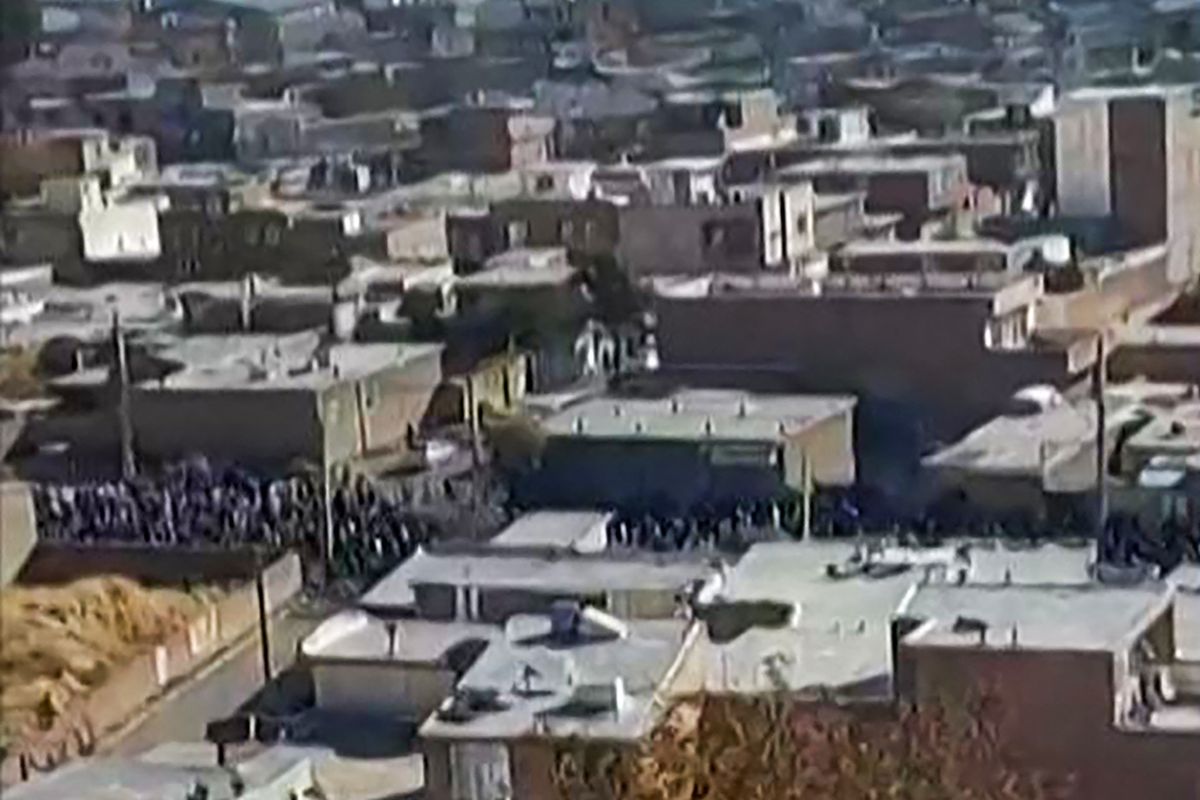 This image grab from UGC video footage made available by the Norway-based Hengaw rights group on November 21, 2022, reportedly shows Iranian protesters marching and chanting slogans in Piranshahr, in western Iran, as they take part in what appears to be a funeral procession for a 16-year-old killed the night before. 