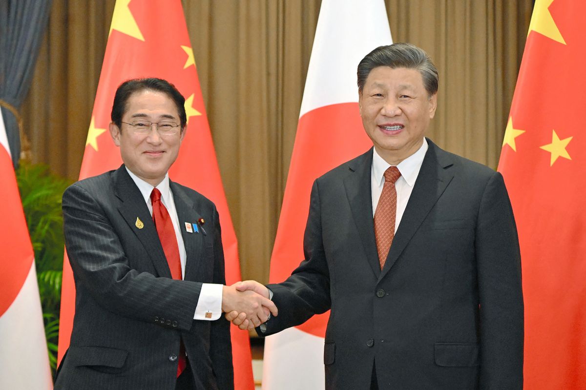 Japan's Prime Minister Fumio Kishida (L) shakes hands with China's President Xi Jinping during their meeting in Bangkok on November 17, 2022, on the sidelines of the Asia-Pacific Economic Cooperation (APEC) Summit. 