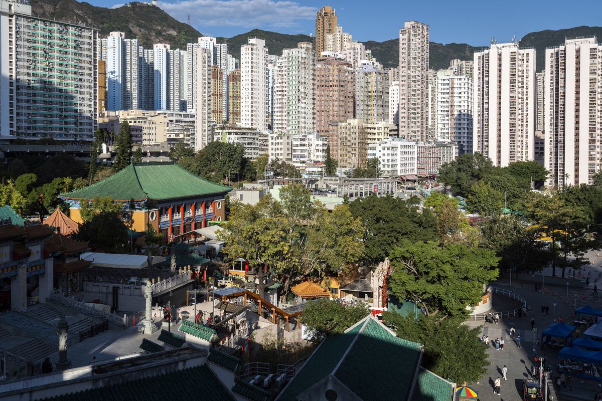 The Wong Tai Sin Temple, bottom left, in front of buildings in Hong Kong, China, on Sunday, Jan. 30, 2022. Hong Kong denied that criticism of the city's strict policy to push for zero Covid-19 cases is illegal under a sweeping national security law that has silenced dissent in the former British colony. Photographer: