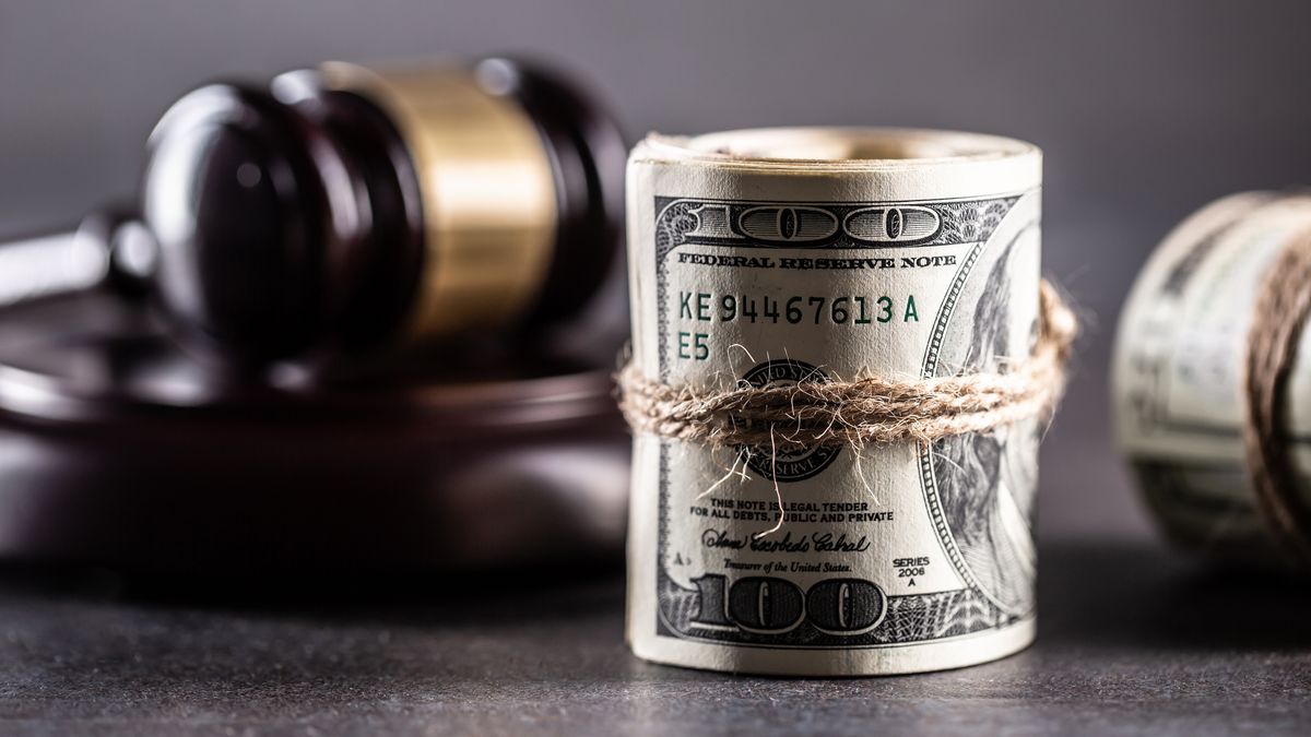 Rolled American bills and Judge's gavel, concept of corruption and bribery, Rolled American bills and Judge's gavel, concept of corruption and bribery