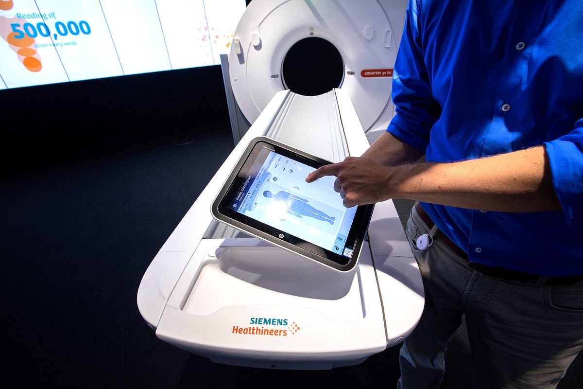 Inside Siemens AG Healthineers Factory As Health-care Division Carve Out Advances An employee uses a tablet device to control a Siemens Artis Q.Zen angiography machine inside the Siemens AG Healthineers showroom in Forchheim, Germany, on Wednesday, July 19, 2017. Siemens said it's moving ahead with a planned split from its health-care division as Europe's largest engineering company whittles down its core holdings to focus on energy and factory equipment. Photographer: Krisztian Bocsi/Bloomberg via Getty Images