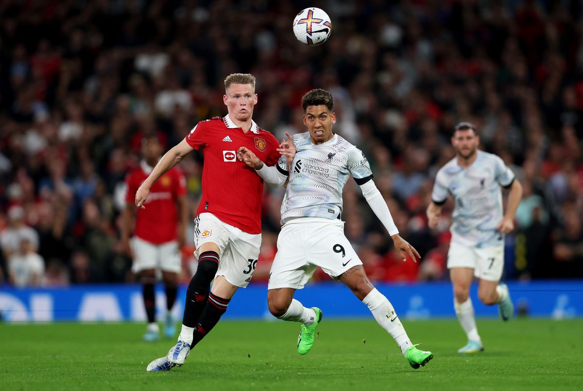 Manchester United v Liverpool FC - Premier League MANCHESTER, ENGLAND - AUGUST 22: Roberto Firmino of Liverpool is challenged by Scott McTominay of Manchester United during the Premier League match between Manchester United and Liverpool FC at Old Trafford on August 22, 2022 in Manchester, England. (Photo by Clive Brunskill/Getty Images)