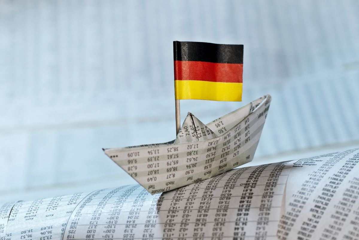 Paper,Boat,With,German,Flag,Shipping,On,Stock,Market,News.