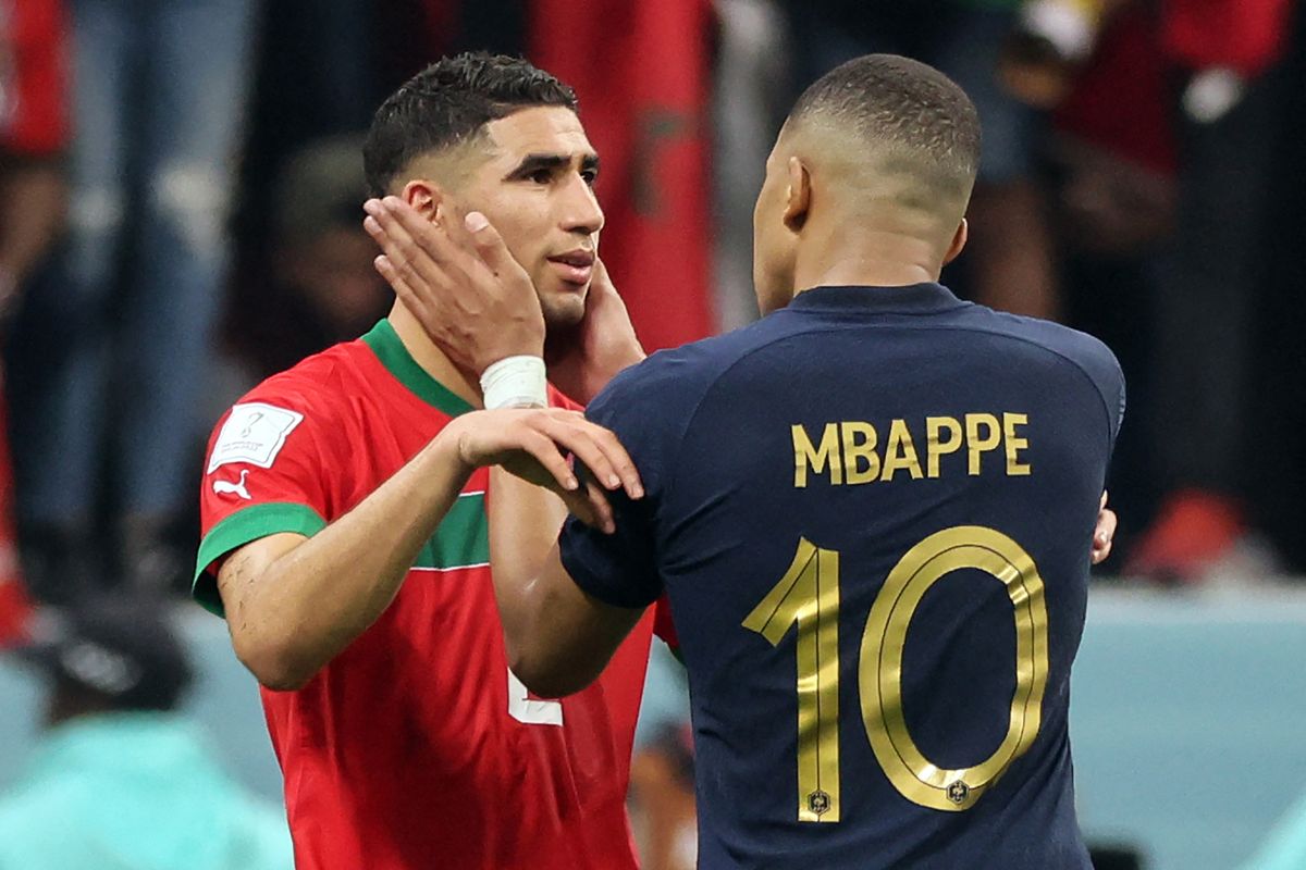 France's forward #10 Kylian Mbappe comforts Morocco's defender #02 Achraf Hakimi at the end of the Qatar 2022 World Cup semi-final football match between France and Morocco at the Al-Bayt Stadium in Al Khor, north of Doha on December 14, 2022. 
