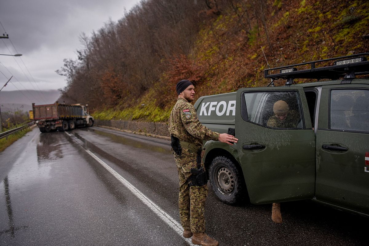 NATO soldiers serving in the peacekeeping mission in Kosovo (KFOR) inspect a road barricade set up by ethnic Serbs near the town of Zubin Potok on December 11, 2022. Hundreds of ethnic Serbs erected barricades on a road in northern Kosovo on Saturday, blocking the traffic over the two main border crossings towards Serbia, police said. Trucks, ambulance cars and agricultural machines were used as roadblocks, heightening recent tensions which included explosions, shootings and an armed attack on a police patrol which saw one ethnic Albanian police officer wounded.
