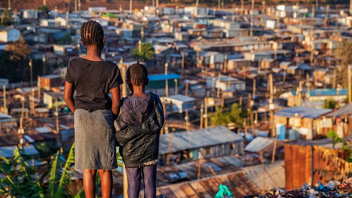 African little girls standing in trash and looking at Kibera slum, Kenya, East Africa African little girls standing in trash and looking at houses in Kibera slum, Kenya, East Africa. Kibera is the largest slum in Nairobi, the largest urban slum in Africa, and the third largest in the world