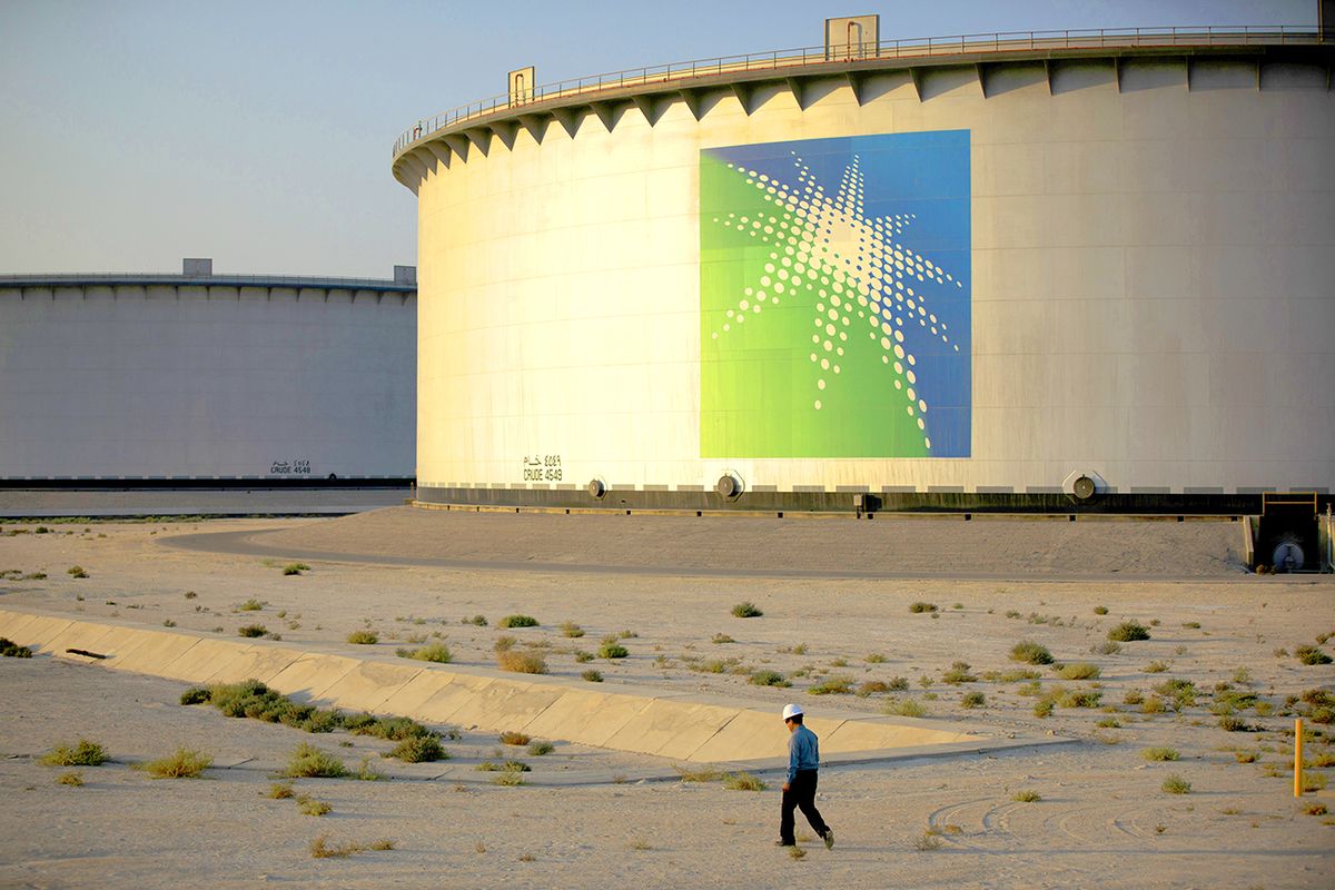 Exclusive: Inside Look At The Saudi Aramco Oil Company An employee walks past crude oil storage tanks at the Juaymah Tank Farm in Saudi Aramco's Ras Tanura oil refinery and oil terminal in Ras Tanura, Saudi Arabia, on Monday, Oct. 1, 2018. Saudi Arabia is seeking to transform its crude-dependent economy by developing new industries, and is pushing into petrochemicals as a way to earn more from its energy deposits. Photographer: Simon Dawson/Bloomberg via Getty Images