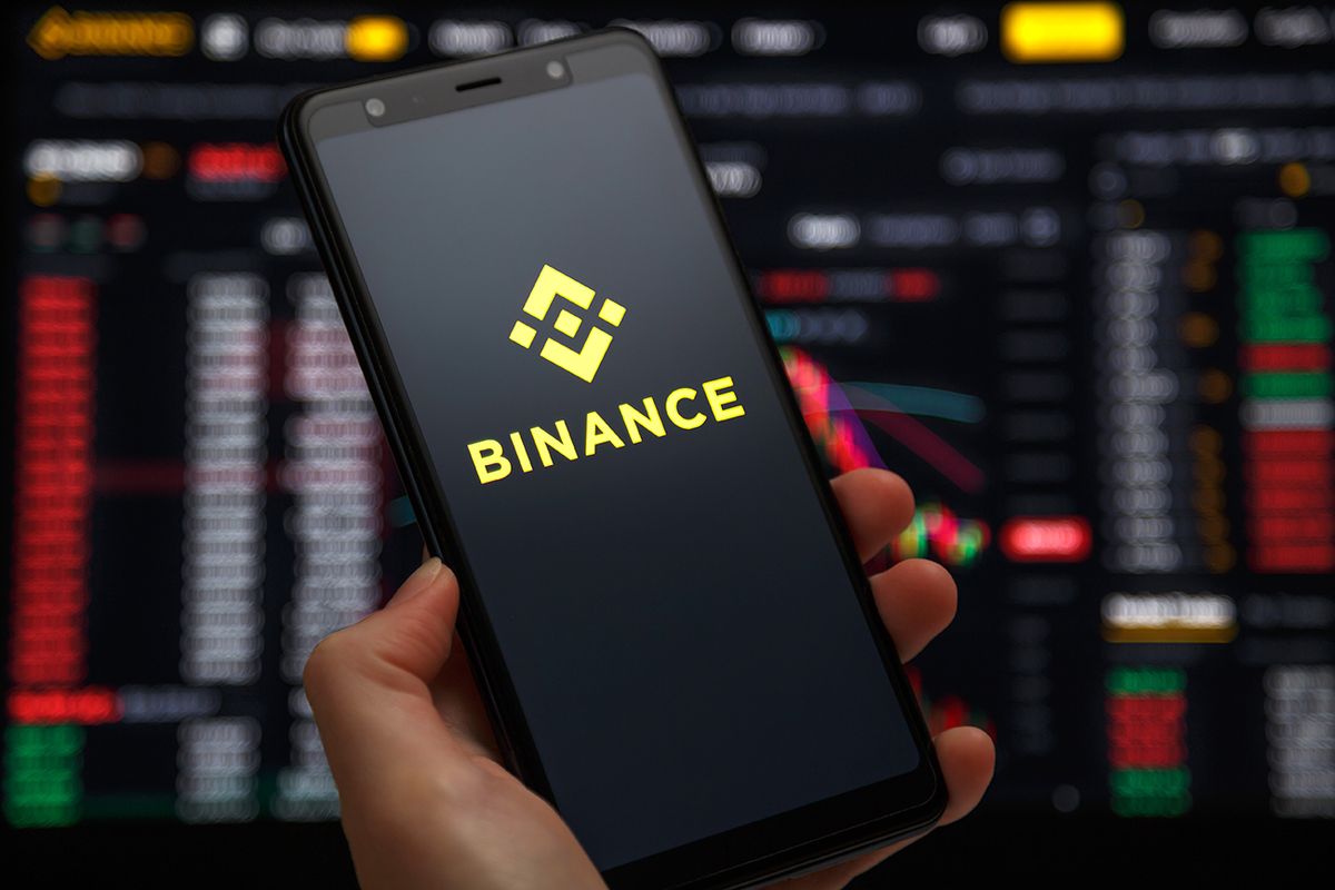 Ukraine,,Odessa,-,June,,1,2021:,Binance,Mobile,App,RunningUkraine, Odessa - June, 1 2021: Binance mobile app running at smartphone screen with a trading page at background. Binance one of the world's leading cryptocurrency exchange and trading platform.